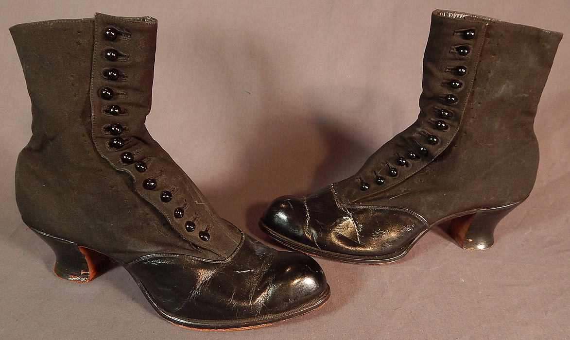 Victorian Womens Black Wool & Leather High Top Button Boots Clarice TC Shoe Co.
They are made of a black patent leather bottom front shoe, with a black wool fabric top. The boots have rounded toes, 14 black shoe buttons along the side for closure and stacked black wooden low French spool heels. 
