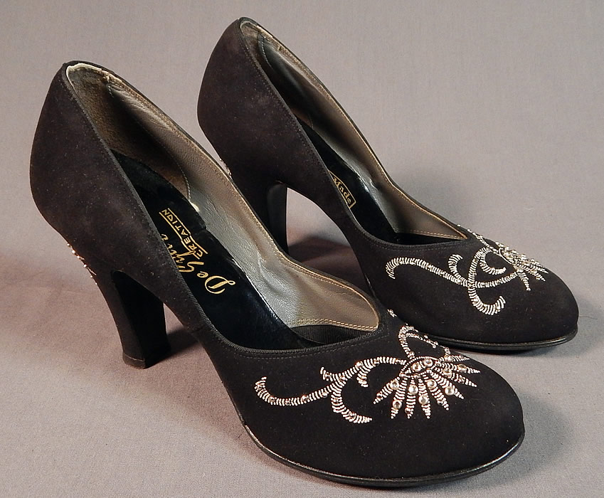 Vintage De Sylvi Creation Hand Painted Black Suede Leather Rhinestone Beaded Shoes
hey are made of a black suede leather, with raised hand painted silver floral leaf decorative designs accented with silver studded rhinestone beadwork on the front toes and heels.