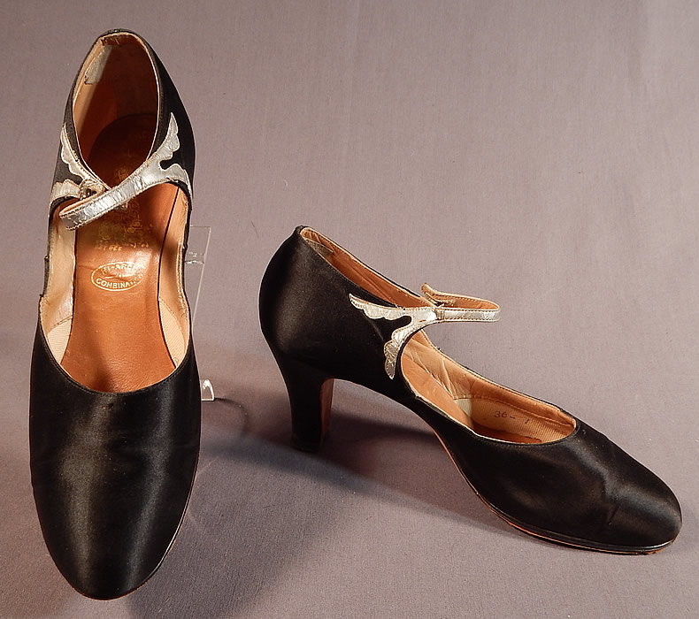 Vintage Peacock Shoe Art Deco Black Silk Satin Silver Button Strap Mary Jane Shoes
These beautiful black evening flapper dance shoes have a Mary Jane style with button strap closure across the instep, rounded toes and black satin covered modified boulevard high heels.