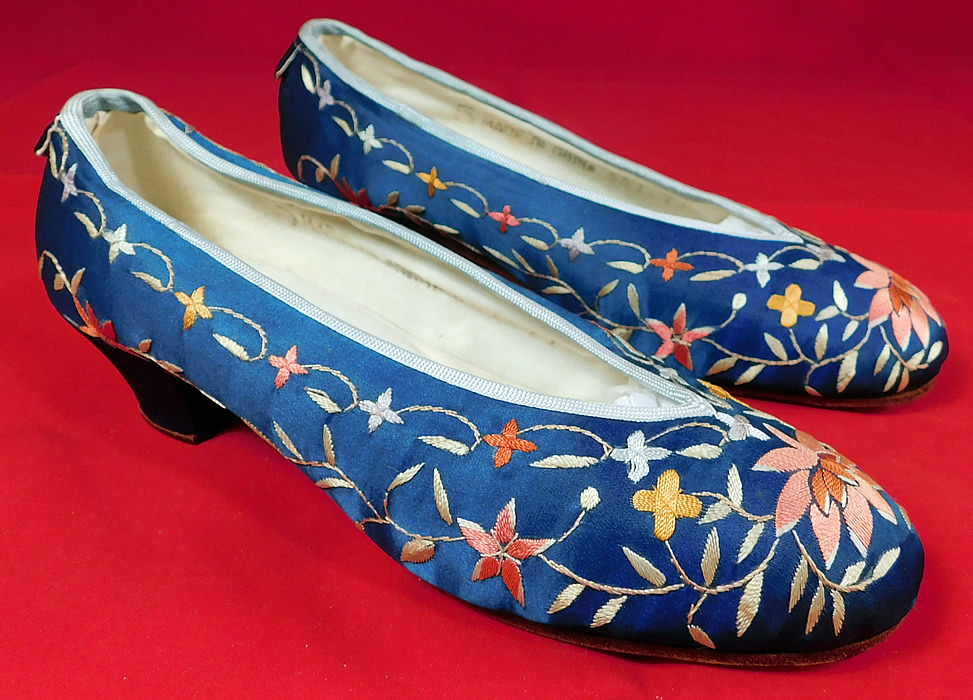 Antique Chinese Blue Silk Colorful Floral Lotus Embroidered Heel Shoes
This pair of vintage Chinese blue silk colorful floral lotus embroidered heel shoes date from the 1920s. 