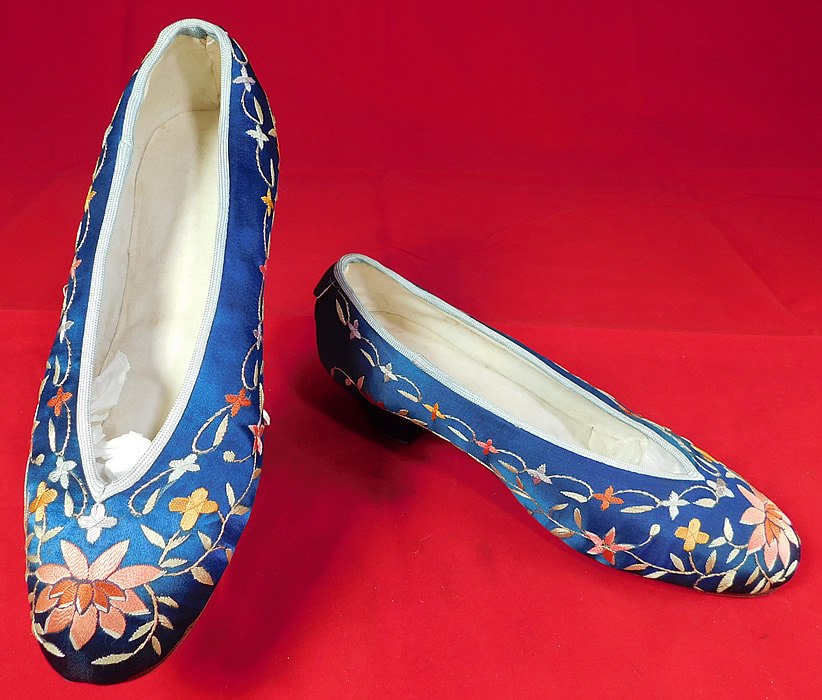 Antique Chinese Blue Silk Colorful Floral Lotus Embroidered Heel Shoes
They are made of a royal blue color silk fabric, with colorful silk raised padded satin stitch hand embroidery work flowers including lotus flowers embroidered on the front toes.