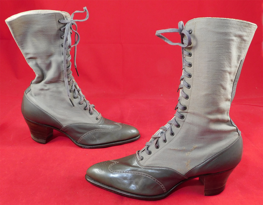 Unworn Edwardian Gray Wool Leather Two Tone High Top Lace-up Boots & Shoe Box
This pair of unworn antique Edwardian era gray two tone wool leather high top lace-up boots and shoe box dates from 1910. They are made of a light dove gray color wool upper boot and slightly darker gray color leather bottom shoe with decorative punch work designs.