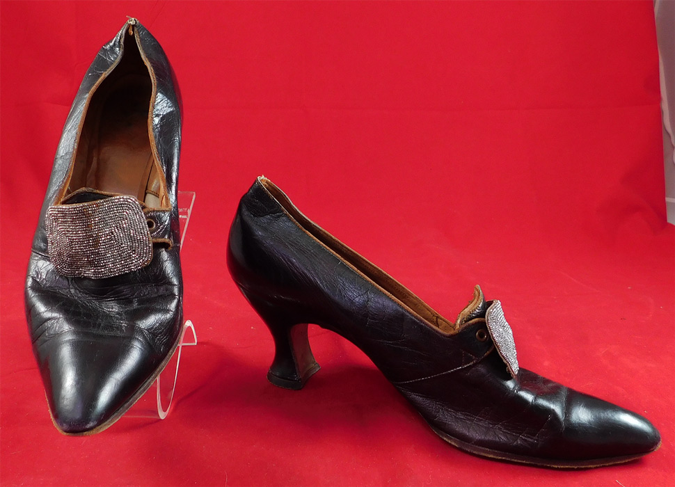 Edwardian Aubergine Leather Steel Cut Beaded Buckle Pointed Toe Shoes
These elegant evening shoes have a slip on slipper style, with exaggerated pointed toes, leather covered French Louis XV spool heels, steel cut beaded buckles and are lined in leather with an embossed stamped "The Emporium San Francisco" store label inside and size 6 AA on the bottom soles. 