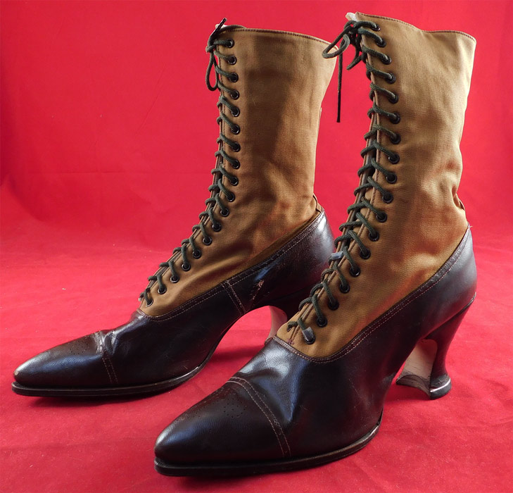Unworn Victorian Two Tone Brown Cloth & Leather High Top Lace-up Boots
These womens beautiful boots have pointed toes, the original brown shoe string laces for closure and stacked wooden Louis XV French spool heels. The boots measure 10 inches tall, 9 1/2 inches long, 2 1/4 inches wide and 2 1/2 inch high heels. 