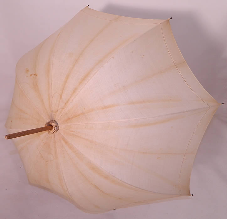 Edwardian Ecru Linen Carved Wood Handle Summer Pagoda Parasol. It is made of an off white ecru cream color linen fabric, with a drawn cut work edging.