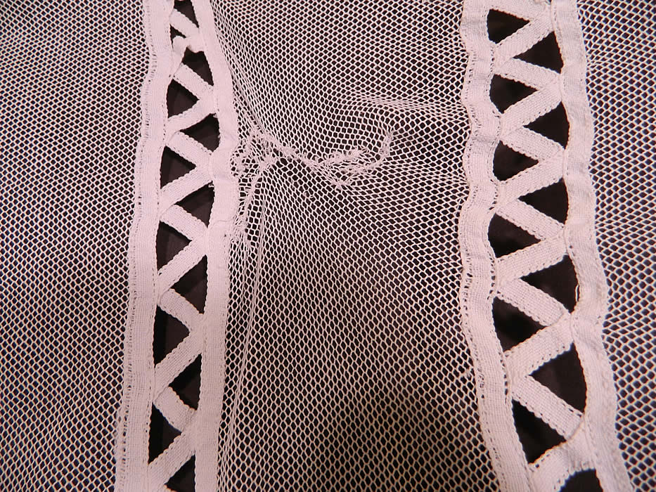 Antique White Battenburg Tape Lace Net Bedspread. The twin size bedspread measures 76 inches long, 50 inches wide, with an additional 16 inch drape dust ruffle on each side including the bottom end. It is in good condition, with two small mended repairs near the top (see close-ups). This is a wonderful piece of antique lace textile art! 