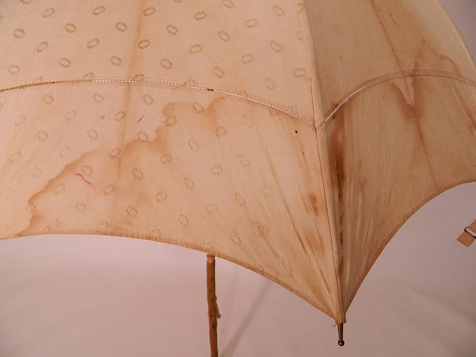 Edwardian Polka Dot Linen Burl Wood Handle Summer Pagoda Parasol close up. It is in good useable condition, but has not been cleaned, with yellowing staining along the folds, water spots and age spot stains. This is a wonderful parasol perfect for an Edwardian era ladies summer outing!