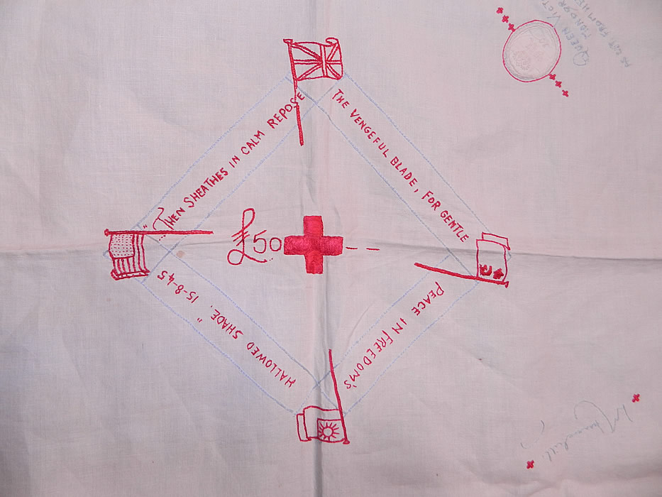 Vintage End of WWII Allies British Red Cross Signature Embroidered Linen Tablecloth. It is made of a white fine Irish linen fabric, with a drawn cut work framed border edging, red and blue hand stitched, embroidered red crosses and signatures. 