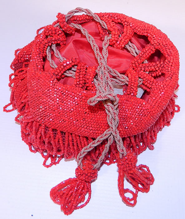 Antique Art Deco Red Beaded Loop Fringe Tassel Drawstring Flapper Purse.This fabulous flapper handbag purse has a drawstring closure on top with silk rope straps. It is fully lined in a red silk fabric inside. The purse measures 9 inches long and and 7 inches wide. It is in excellent condition. 