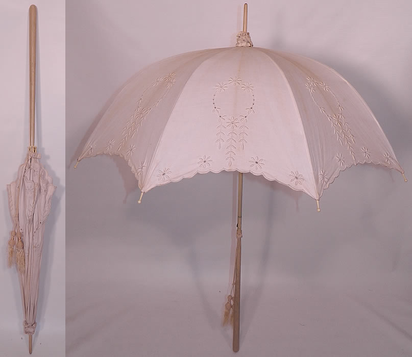 Edwardian Eyelet Embroidered White Linen Wood Handle Summer Parasol. This antique Edwardian era eyelet embroidered white linen wood handle summer parasol dates from 1910. It is made of white linen fabric, with eyelet cut work and raised padded satin stitch hand embroidery work.