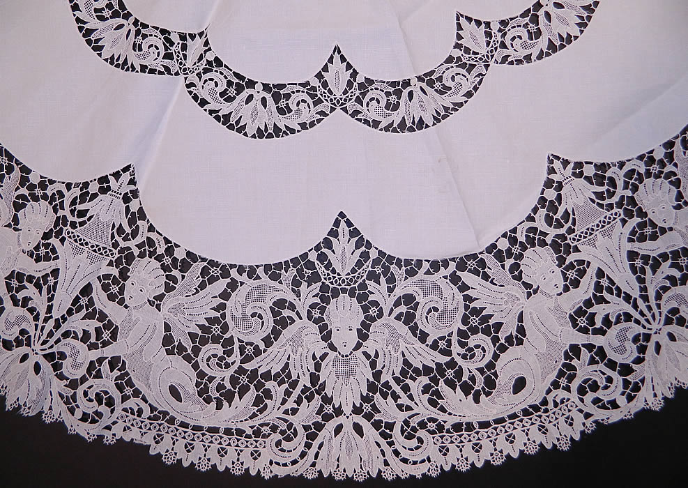Victorian Antique Point de Venise Lace Renaissance Cupid Linen Round Tablecloth. There is a decorative Renaissance inspired allegorical design with cupid angels and urns done in lace. 