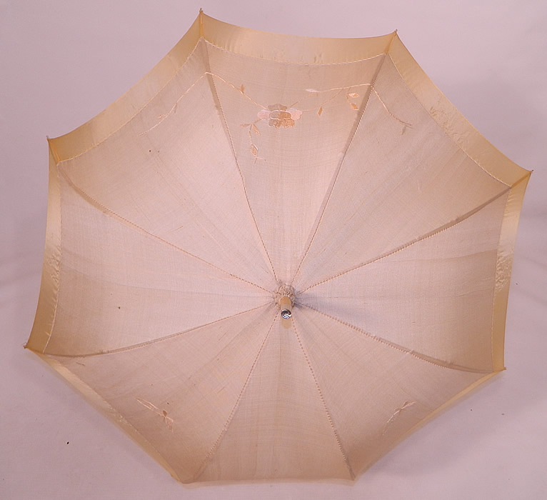 Edwardian Ecru Cream Silk Embroidered Folding Wood Handle  Pagoda Parasol. There is a unique folding wood handle with brass chain link mechanism, wood and metal capped tip finial top with gathered scrunchie fabric and silk tassel trim.