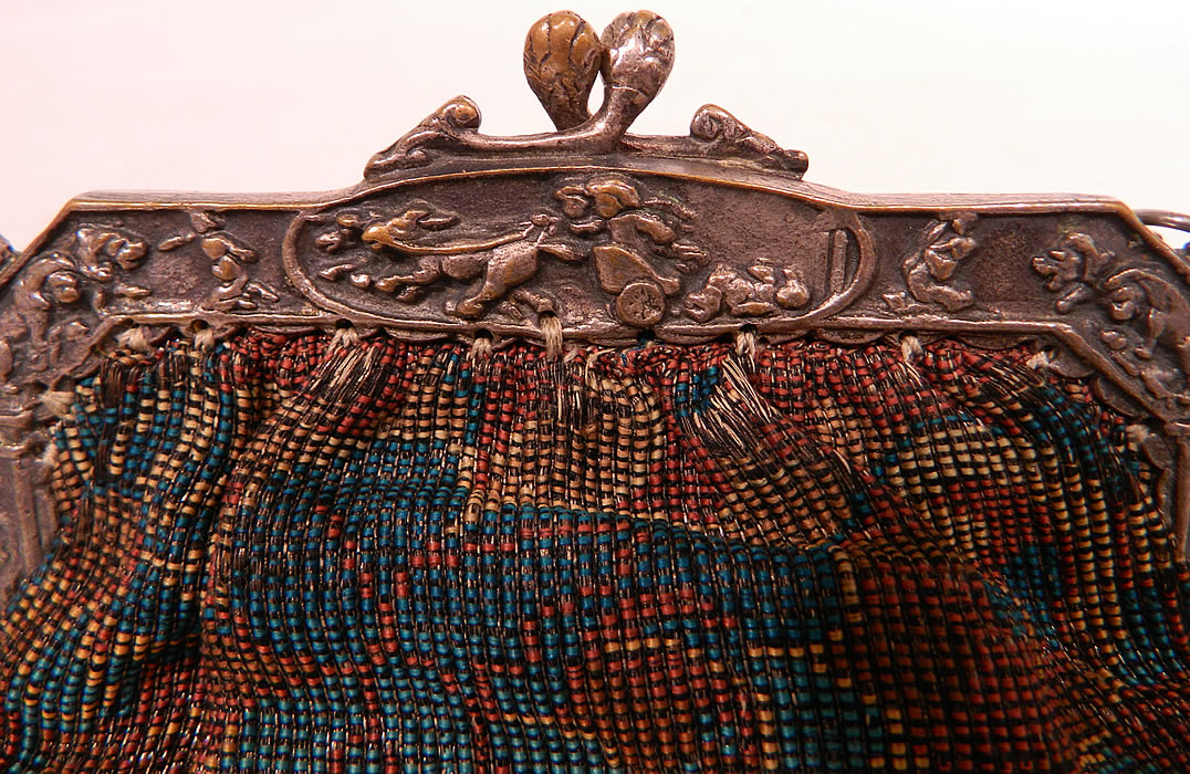 Antique Silver Plate Repousse Dog Cart Frame Floral Needlepoint Embroidery Purse
There is a dog paw silver ball clasp closure on the top and chain link strap. The purse is made of varying shades of blue and brown silk thread needlepoint embroidery work with a floral pattern design. 