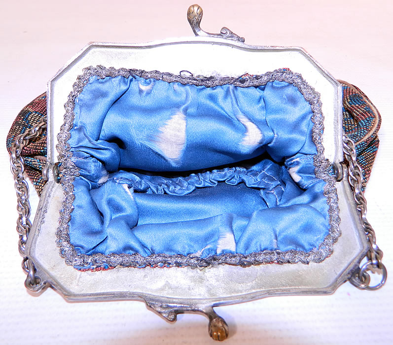 Antique Silver Plate Repousse Dog Cart Frame Floral Needlepoint Embroidery Purse
The purse measures 8 inches tall and 9 inches wide. It is in good condition, with some splits inside on the blue silk lining, a frayed loose cord binding along the bottom and a few tiny frays along the top frame (see close-ups). This is truly a wonderful piece of textile art! 