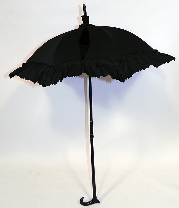 Victorian Civil War Black Silk Ebony Folding Handle Marquis Mourning Parasol
This antique Victorian Civil War era black silk ebony folding handle marquis mourning parasol dates from the 1860s.