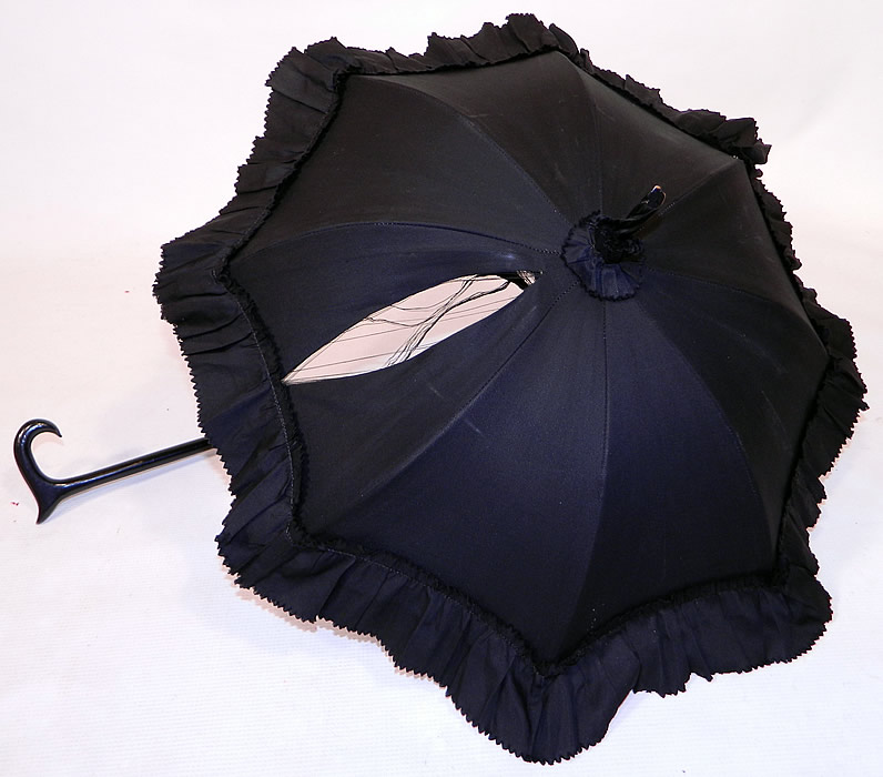 Victorian Civil War Black Silk Ebony Folding Handle Marquis Mourning Parasol
It is lined inside with black silk. The parasol measures 27 inches long extended, 16 inches long when folded and the fabric outside is 56 inches in circumference when opened up. 