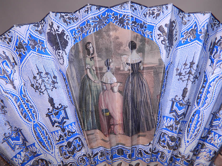 Victorian Lithograph Silver Foil Inlay Pierced Pleated Folding Fan
It is made of pleated paper with silver foil embossing, hand colored painted lithographs and a blue background on one side and white on the other.