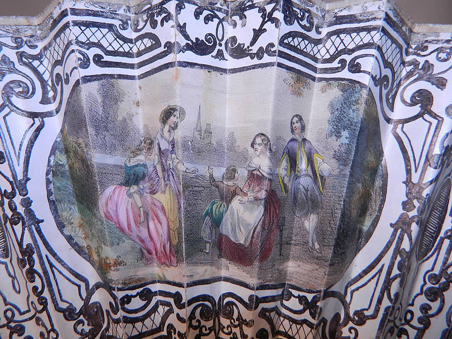 Victorian Lithograph Silver Foil Inlay Pierced Pleated Folding Fan
The fan measures 10 1/2 inches long and 22 inches wide when opened. 