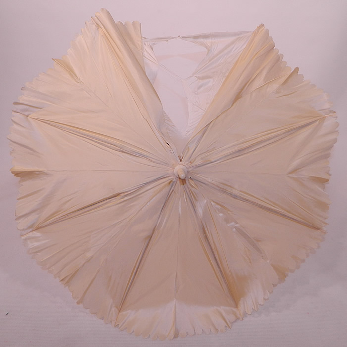 Victorian Cream Silk Carved Chain Link Wrapped Handle Parasol Tassel Trim
It is lined in a white silk fabric. The parasol measures 26 inches long and is 72 inches in circumference when opened up. It is in as-is fair condition, with several splits in the outer silk fabric and inside lining (see close-up). This is truly a wonderful wedding parasol which could be recovered and is in fine working order! 