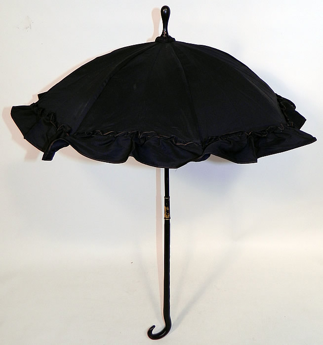 Victorian Civil War Black Silk Ebony Folding Handle Marquis Mourning Parasol
There is a black ebony wood carved fish hook handle and folding shaft, with a marquis tilt top mechanism inside to keep the sun off your face. 