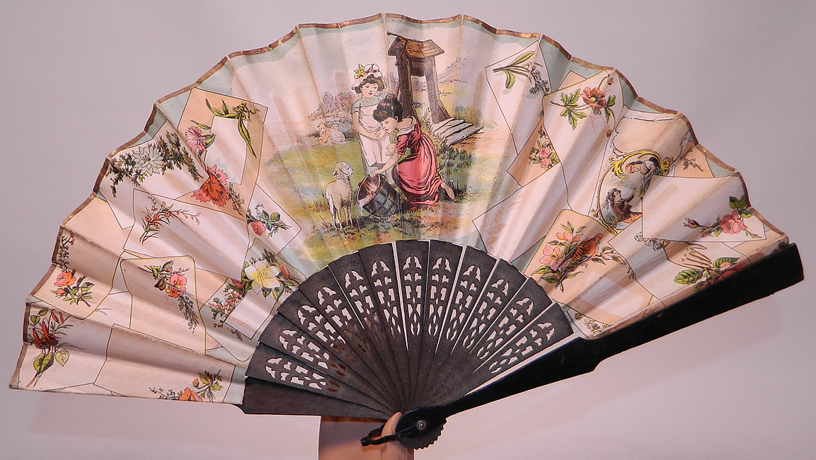 Victorian Lithograph Calling Cards Autograph Paper Pleated Folding Fan
This antique Victorian era lithograph calling cards autograph paper pleated folding fan dates from the 1890s. It is made of pleated paper with hand colored painted lithographs of calling cards bearing decorative designs of flowers, a beautiful vignette of children with lambs at the well, gold foil trim along the top and glossy black paper backing. 