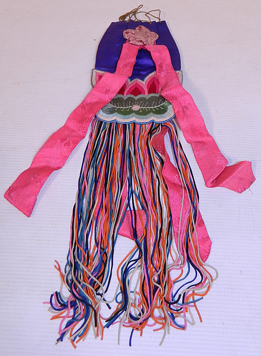 Antique Chinese Colorful Silk Embroidered Lotus Flower Fringed Pouch Purse Bag
There is multicolored silk fringe trim hanging down from the bottom, pink silk damask brocade woven ribbon streamers and a cotton calico print fabric rosette appliqu&eacute; trim. This pretty pouch purse bag has a drawstring gold rope top closure, colorful long fringe bottom and is fully lined in linen.