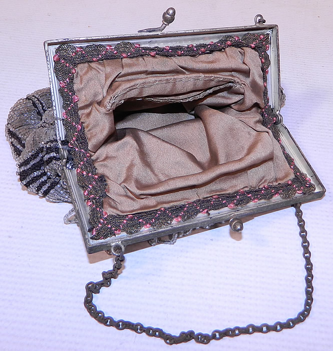 Vintage Art Deco Black Knit Crystal Beaded Loop Fringe Silver Frame Flapper Purse
The purse measures 8 1/2 inches long and 6 1/2 inches wide. It is in excellent condition, with no loose or missing beads. This is truly a wonderful piece of antique beaded textile art!