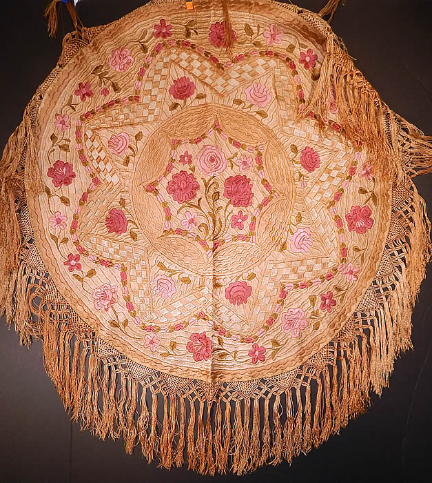 Antique Matyo Hungarian Folk Embroidery Pink Floral Fringe Round Tablecloth
This antique Hungarian Matyo folk embroidery pink floral fringe round tablecloth dates from the 1920s. It is hand stitched, made of varying shades of pinks, ecru beige and green silk threads done in raised padded satin stitch Matyo embroidery work completely covering the entire linen fabric. There is an eight point star design in the center, checkered, scalloped patterns, with a floral vine leaf design densely embroidered onto the fabric in a circular pattern and hand knotted macrame silk fringe trim edging.