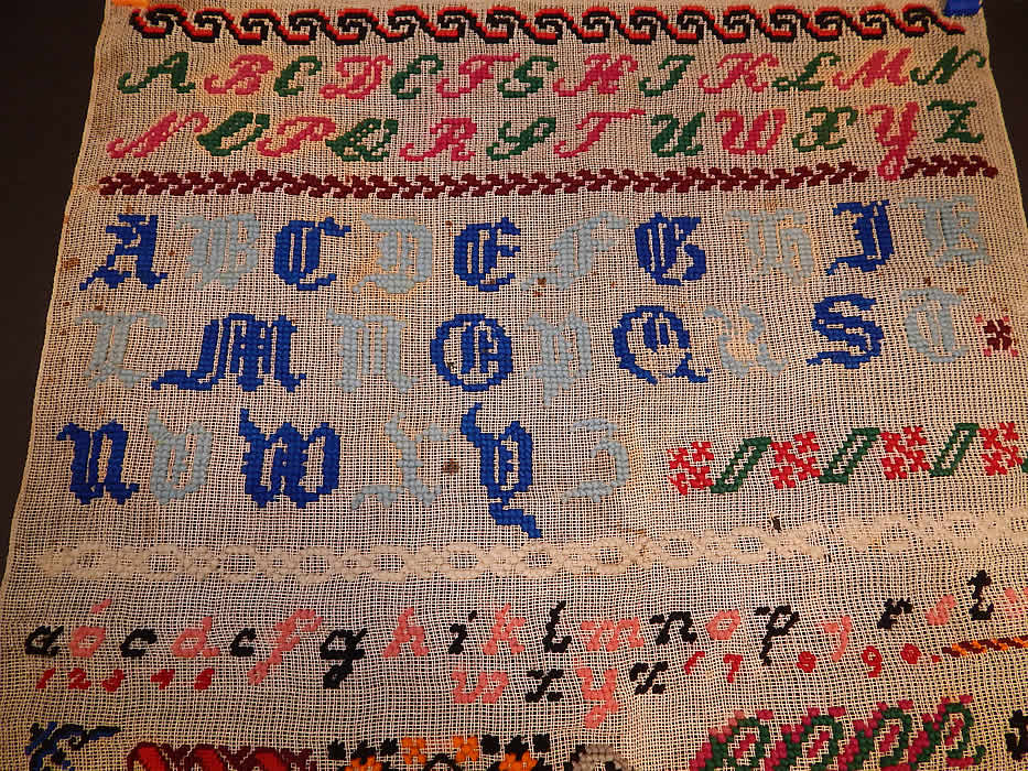 Victorian Antique 1898 Berlin Wool Work Embroidery Needlepoint Sampler
The alphabet and numbers 1-10 are embroidered across the top, with a nautical anchor, ships wheel, horse, griffin, dragon, butterfly, cross, grape vine leaf, flowers and other decorative pattern designs along the mid section and bottom. 
