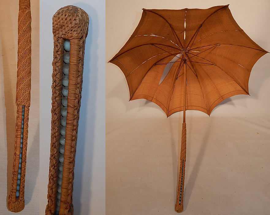 Edwardian Ecru Burlap Cloth Natural Straw Basketweave Handle Summer Parasol
There is a natural straw woven basketweave handle with turquoise blue glass bead balls inserted inside and a wooden stick body with metal capped tip finial top. 