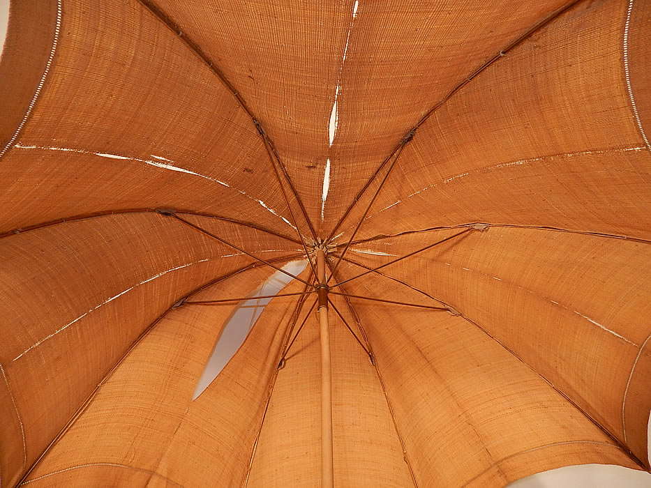 Edwardian Ecru Burlap Cloth Natural Straw Basketweave Handle Summer Parasol
The parasol measures 41 inches long and 94 inches in circumference when opened. It is in as-is fair condition, with several frayed rips on the cloth fabric and the handle is slightly bent. This is a wonderful parasol perfect for an Edwardian era ladies summer outing!