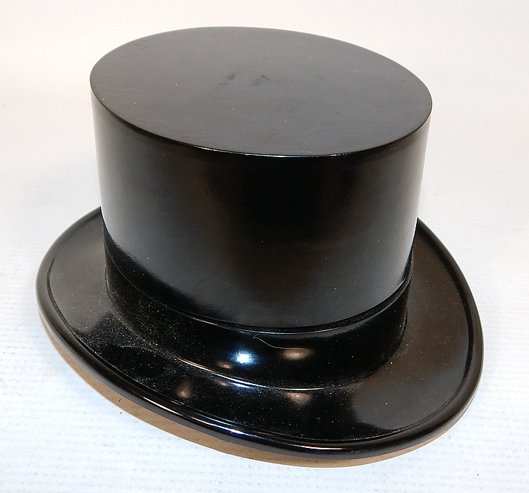 Vintage Paris Top Hat Box Never Used Mens Sock Garters & Suspenders Braces
There is a decorative black plastic top hat container which opens up to expose the inside contents, brown satin sock garters and brown, white striped suspenders braces, with gold metal hardware and stamped "Paris" brand. 
