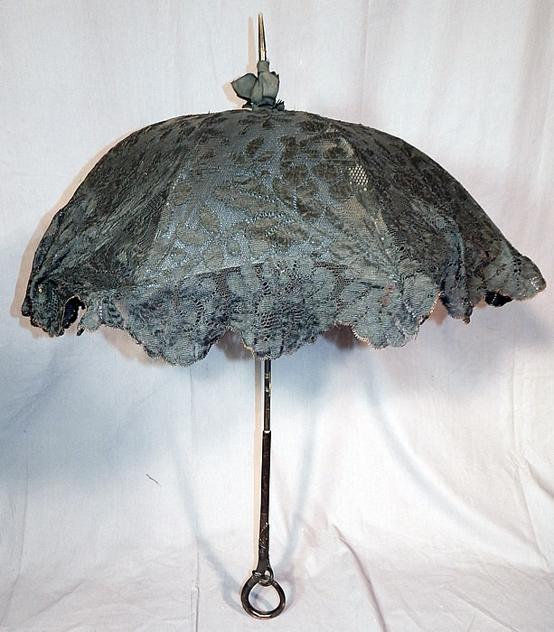 Edwardian Art Nouveau Antique Black Lace Carved Ebony Wood Handle Parasol
This pretty parasol has a beautifully carved black ebony wood handle with round loop bottom, metal capped tip finial top with black silk ribbon bow trim and is fully lined in black silk, with a black metal frame inside in fine working order. 