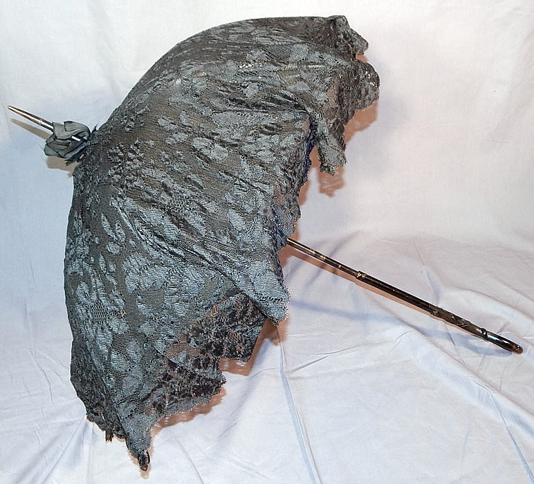 Edwardian Art Nouveau Antique Black Lace Carved Ebony Wood Handle Parasol
The parasol measures 40 1/2 inches long and is 29 inches wide across the spokes when opened. 