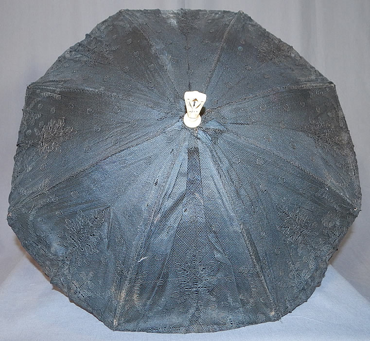 Victorian Antique Black Chantilly Lace Carved Pierced Finial Handle Parasol
The parasol measures 23 inches long, with a 6 inch long bone handle and is 55 inches in circumference when opened up.