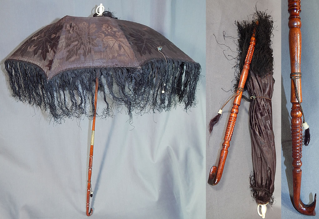 Victorian Antique Black Silk Damask Maple Leaf Carved Wood Folding Handle Parasol
It is made of a faded black silk damask weave maple leaf pattern brocade fabric, with dark black silk fringe trim edging along the bottom. 