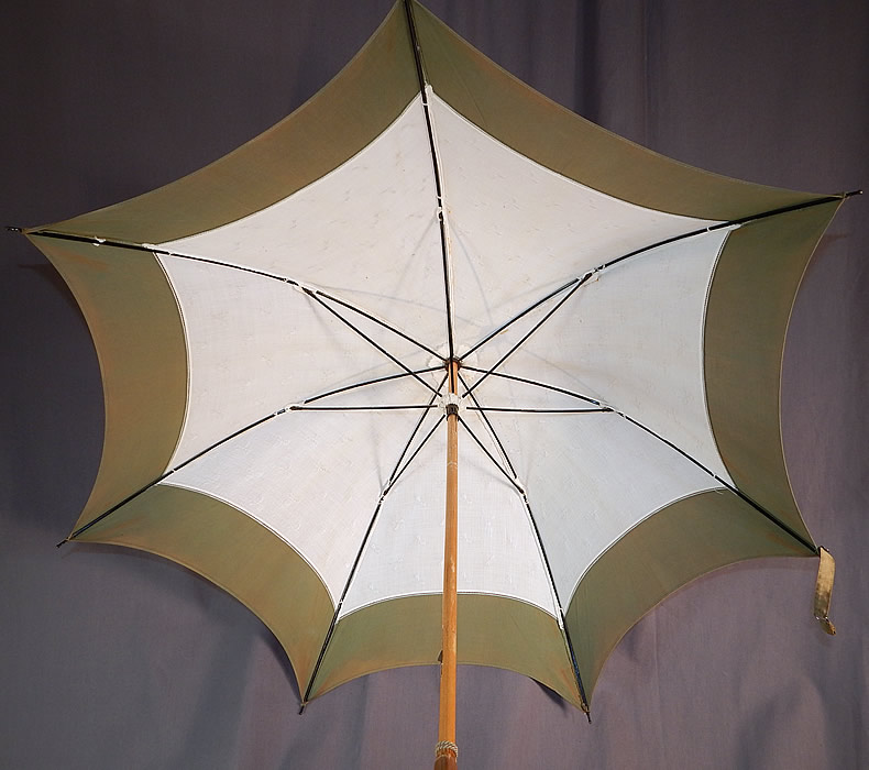 Edwardian White Cotton Damask Bow Green Trim Wood Handle Summer Parasol
There is an oak wood handle stick, finial top with green gathered fabric trim. This summertime pretty parasol umbrella has a pagoda dome shape, with black metal frame inside, unlined, original button strap for keeping closed and green rope tassel trim hanging down the stick.