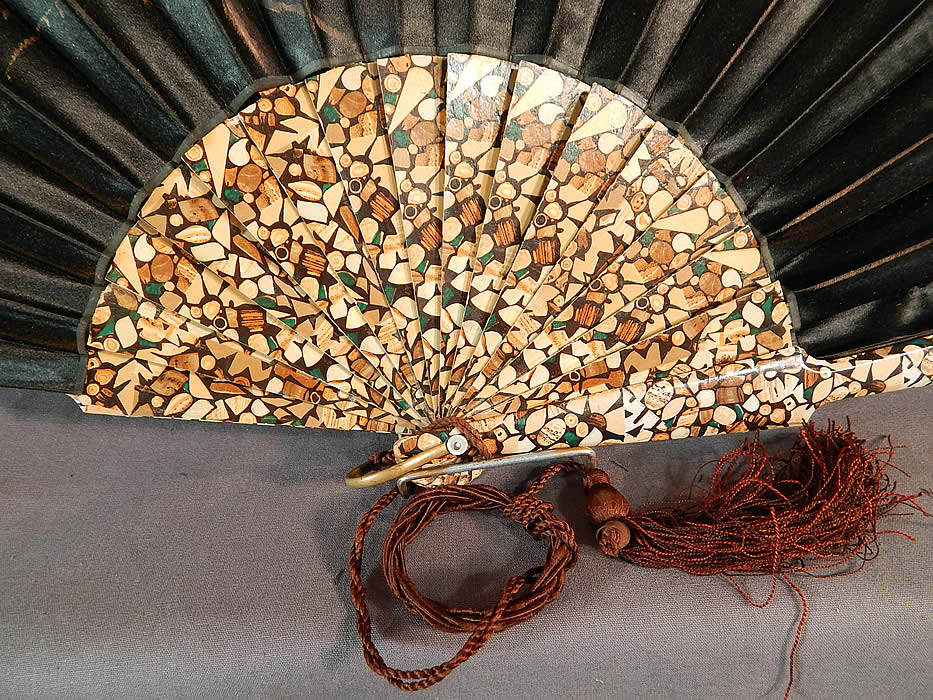 Victorian Black Silk Hand Painted Magnolia Chickadee Birds Decoupage Folding Fan
This fabulous fan has a unique mosaic style wood grain decoupage wooden sticks and guards, with a gold brass loop ring, mother of pearl rivet holding the fan together and a brown silk tassel, finger loop hanging down from the bottom. 