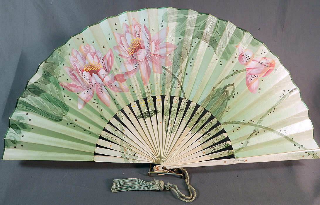 Art Nouveau Asian Hand Painted Paper Lotus Flower Sequin Pleated Folding Fan
This Edwardian era antique Art Nouveau Asian hand painted paper lotus flower sequin pleated folding fan dates from 1910. 