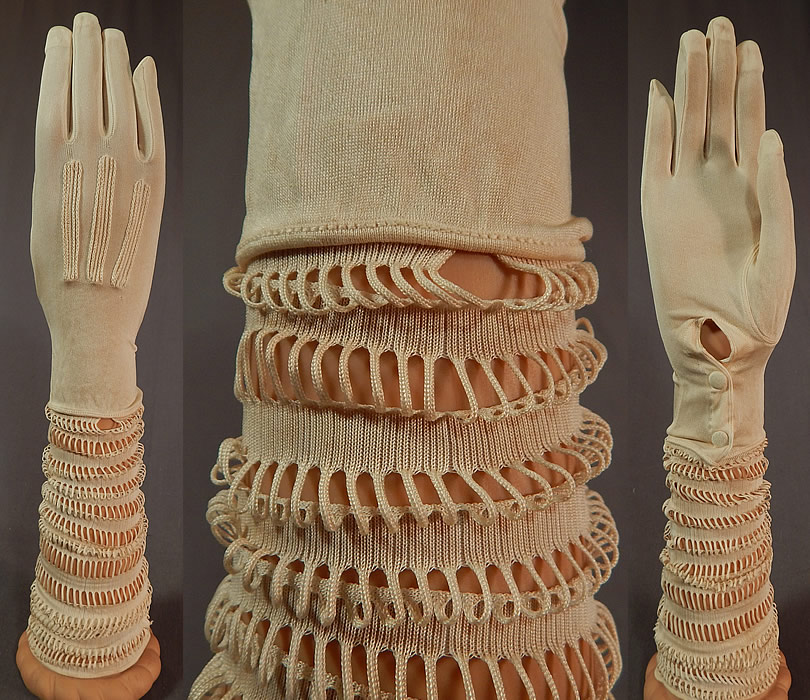 Vintage Art Deco Cream Silk Knit Cutwork Long Elbow Length Bridal Wedding Gloves
This pair of vintage Art Deco cream silk knit cutwork long elbow length bridal wedding gloves date from the 1920s. It is made of an off white cream color fine silk knit fabric, with rows of decorative cutwork loops going down the arm creating a slouching style. These beautiful bridal wedding gloves are a long elbow length, with decorative striped stitching on the hands and silk covered snap button closures on the inside wrists. 