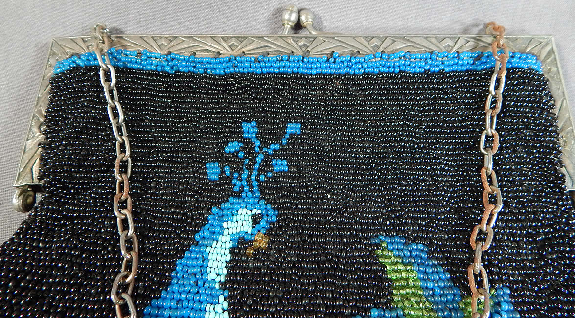 Antique Art Deco Blue Peacock Bird Beaded Figural Flapper Purse
The purse measures 10 inches long and 8 inches wide. It is in excellent condition, with no missing or loose beads. This is truly a rare and exquisite piece of Art Deco antique beaded textile art! 