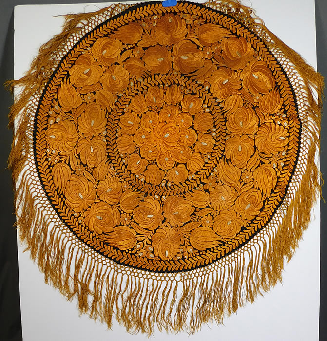 Antique Matyo Hungarian Folk Embroidery Yellow Floral Fringe Round Tablecloth
This antique Hungarian Matyo folk embroidery yellow floral fringe round tablecloth dates from the 1920s. It is hand stitched, made of golden yellow silk threads done in raised padded satin stitch Matyo embroidery work completely covering the entire black linen fabric underneath. 