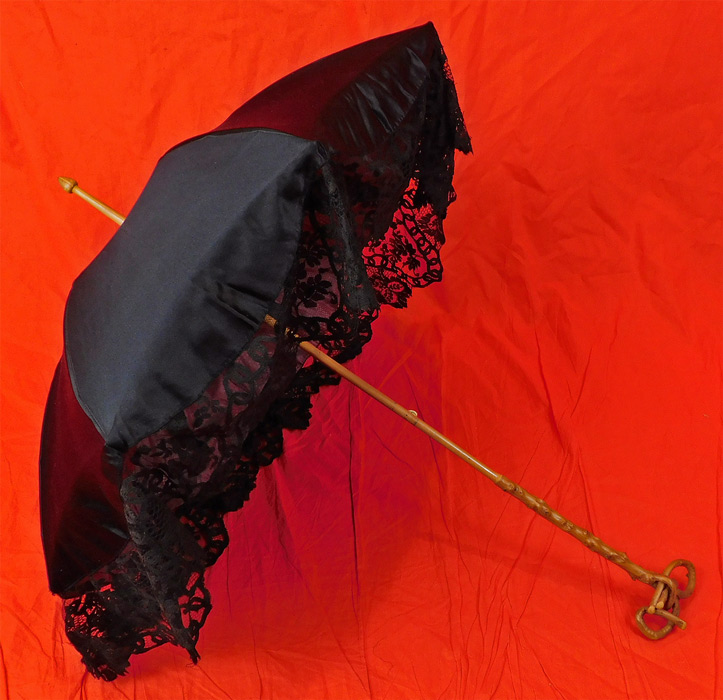 Edwardian Antique Black Silk Lace Burl Wood Stafford Knot Handle Parasol
The parasol measures 37 inches long. It is in good as-is condition, with only the inside silk lining shattered and frayed needing removing or replacing.
